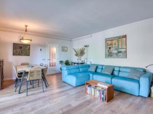 a living room with a blue couch and a table at Casa Villa Palafrugell 1506 in Palafrugell