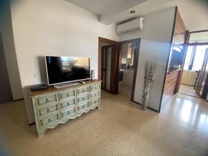 A television and/or entertainment centre at Playamar Primera linea front beach