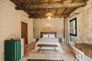 a bedroom with a bed and a green refrigerator at Suare Alaçatı in Alacati +88 photos