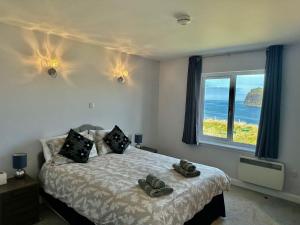 a bedroom with a bed with a view of the ocean at Eas Mor in Glendale