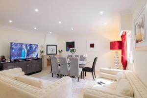 a living room with white furniture and a dining room at Sunny, The House - AL in Faro