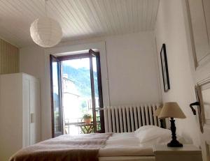 a bedroom with a bed and a large window at Appartement Alexandra in Chamonix-Mont-Blanc +9 photos