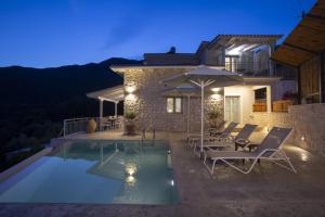 a villa with a swimming pool at night at Panoutsis Villa - Sivros Lefkada in Sívros
