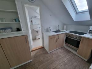 a kitchen with a sink and a stove at " Ferienhaus Vadersdorf" Wohnung 3 in Vadersdorf