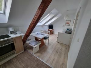 a kitchen and living room with a table and a dining room at " Ferienhaus Vadersdorf" Wohnung 3 in Vadersdorf
