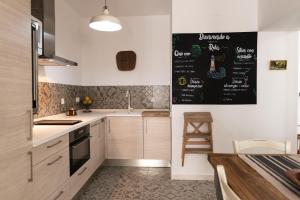 a kitchen with a chalkboard on the wall at Rosario17 by 7Escalones in Rota