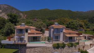 a large house on the side of a mountain at Panoutsis Villa - Sivros Lefkada in Sívros