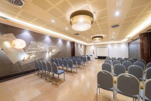 una sala conferenze con sedie e una lavagna bianca di Iberik Santo Domingo Plaza Hotel a Oviedo