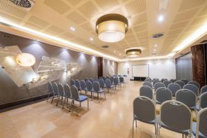 a conference room with chairs and a whiteboard in it at Iberik Santo Domingo Plaza Hotel in Oviedo
