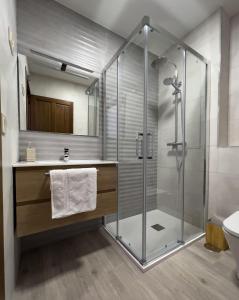 a bathroom with a glass shower and a sink at Casalagata in Alcántara