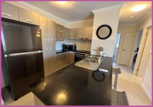 a kitchen with a black refrigerator and a counter top at Angus Smith Drive 28/319 in Ross River