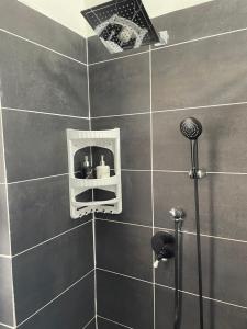 a bathroom with a shower with a shower head at Camera in centro storico in Olbia +62 photos