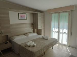 Postel nebo postele na pokoji v ubytování Hotel Gioiella
