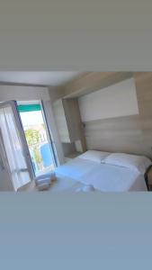 Postel nebo postele na pokoji v ubytování Hotel Gioiella