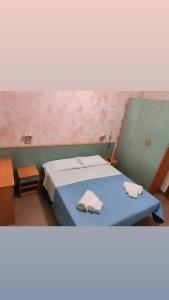 Postel nebo postele na pokoji v ubytování Hotel Gioiella