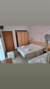 Postel nebo postele na pokoji v ubytování Hotel Gioiella