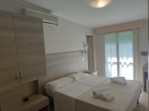Postel nebo postele na pokoji v ubytování Hotel Gioiella