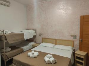 Postel nebo postele na pokoji v ubytování Hotel Gioiella