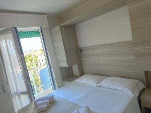 Postel nebo postele na pokoji v ubytování Hotel Gioiella
