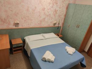 Postel nebo postele na pokoji v ubytování Hotel Gioiella