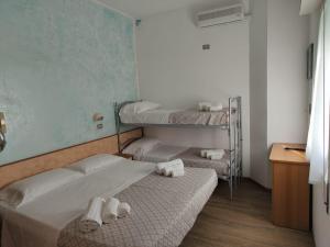 Postel nebo postele na pokoji v ubytování Hotel Gioiella