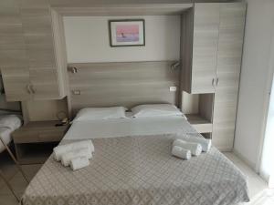 Postel nebo postele na pokoji v ubytování Hotel Gioiella