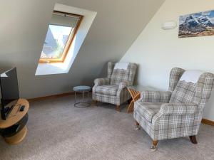 a living room with two chairs and a tv at Newton Bothy in Stirling