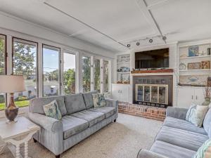 a living room with a couch and a fireplace at Bikini Top & Bottom in Tybee Island