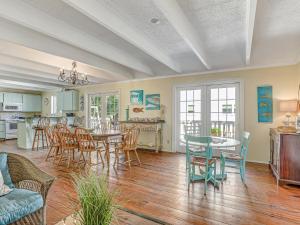 a kitchen and dining room with a table and chairs at Bikini Top & Bottom in Tybee Island