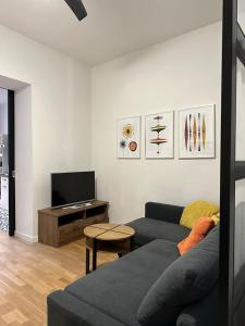 a living room with a couch and a tv at Apartman Nevenka in Varaždin