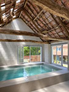 a swimming pool in a house with a wooden ceiling at seixurra 31 in A Coruña