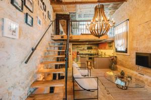 a room with a staircase with chairs and a table at Suare Alaçatı in Alacati