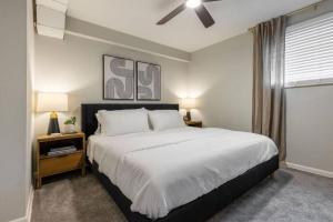 a bedroom with a large bed with a ceiling fan at Maple Heights Retreat in Maple Heights