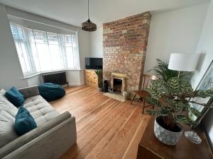 a living room with a couch and a fireplace at Stylish Unique 3 Bedroom House Hastings in Hastings