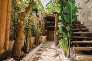 a hallway with stairs and plants in a building at Suare Alaçatı in Alacati