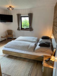 a bedroom with a large bed and a window at SapplAlm in Millstatt