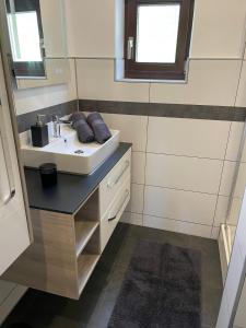 a bathroom with a sink and a mirror at SapplAlm in Millstatt +36 photos