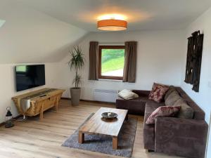 a living room with a couch and a table at SapplAlm in Millstatt