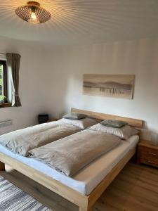 a large bed in a bedroom with a ceiling at SapplAlm in Millstatt