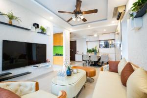 a living room with a couch and a tv at Awesome Tracy's Apartment in Ho Chi Minh City