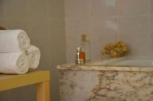 a bathroom with a bath tub and a pile of towels at Hotel Nuevo Parranda in Camariñas +11 photos