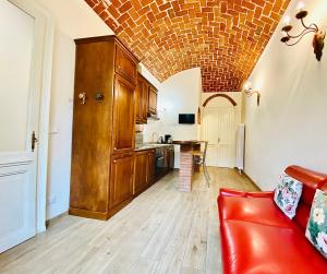 Una sala de estar con un sofá rojo y una cocina. en Exquisitely renovated and centrally located apartment with free parking, en Turín 8 fotos más