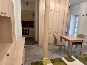 a kitchen and dining room with a table and chairs at Infinity Apartman in Esztergom