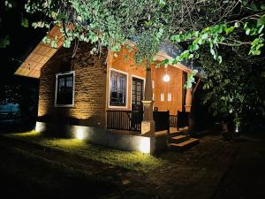 a brick house with a porch at night at Ranakeliya Lodge - Yala in Yala