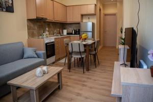 a kitchen and living room with a couch and a table at Corfu Town Cozy Apartment in Ágios Rókkos