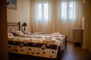a bedroom with a bed with towels on it at Corfu Town Cozy Apartment in Ágios Rókkos