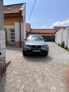 a car parked in front of a house at Infinity Apartman in Esztergom