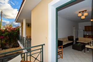 a balcony with a view of a living room at Kefalonia, Lixouri family friendly house & parking in Lixouri