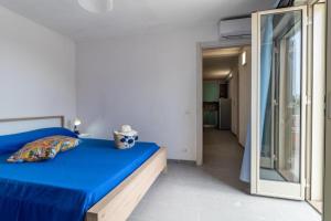- une chambre avec un lit bleu et un miroir dans l'établissement Oasi del mare, à Granelli