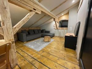 a living room with a couch and a table at Backyard Mountain Hostel in Mayrhofen